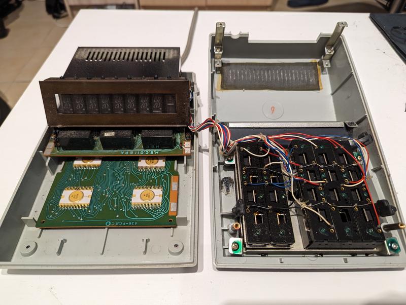 The lower and upper halves of the calculator; the first one contains the main circuit and the display, the second one contains the keyboard circuitry.